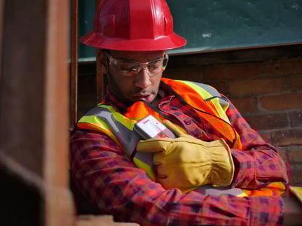 Blackline-Safety-Loner-M6-worker-using-speakerphone-700x525-700x525