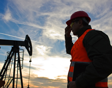 lone-worker-standing-near-oil-extraction