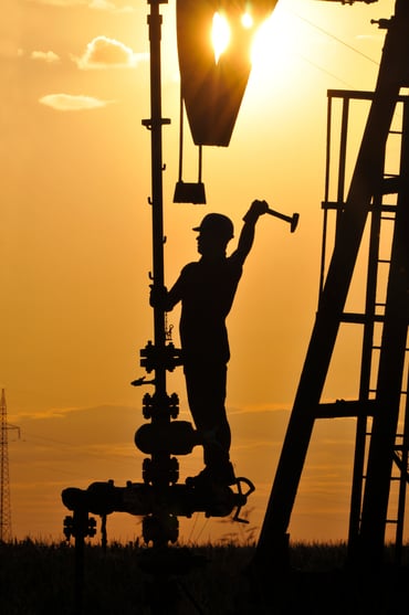 Worker on stack at sunset