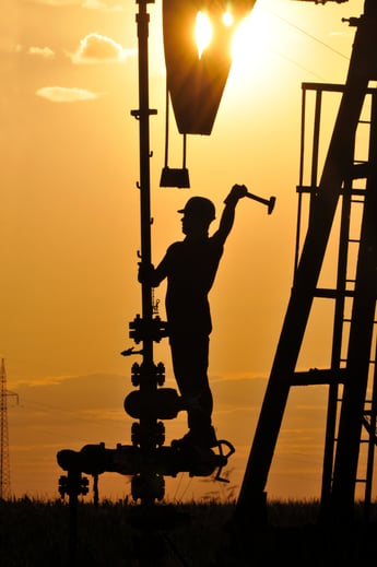 Worker on stack at sunset